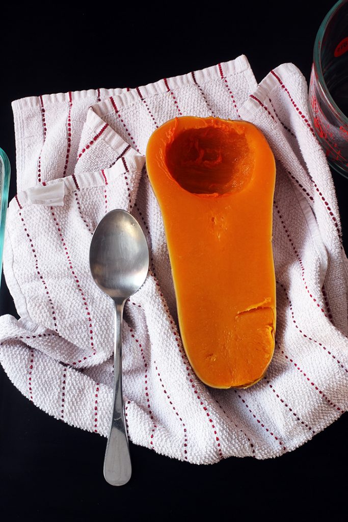 cooked squash and spoon on towel