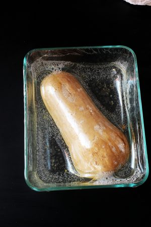 cooked squash in dish, covered with plastic wrap