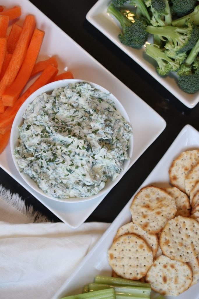 healthy spinach dip with veggies and crackers