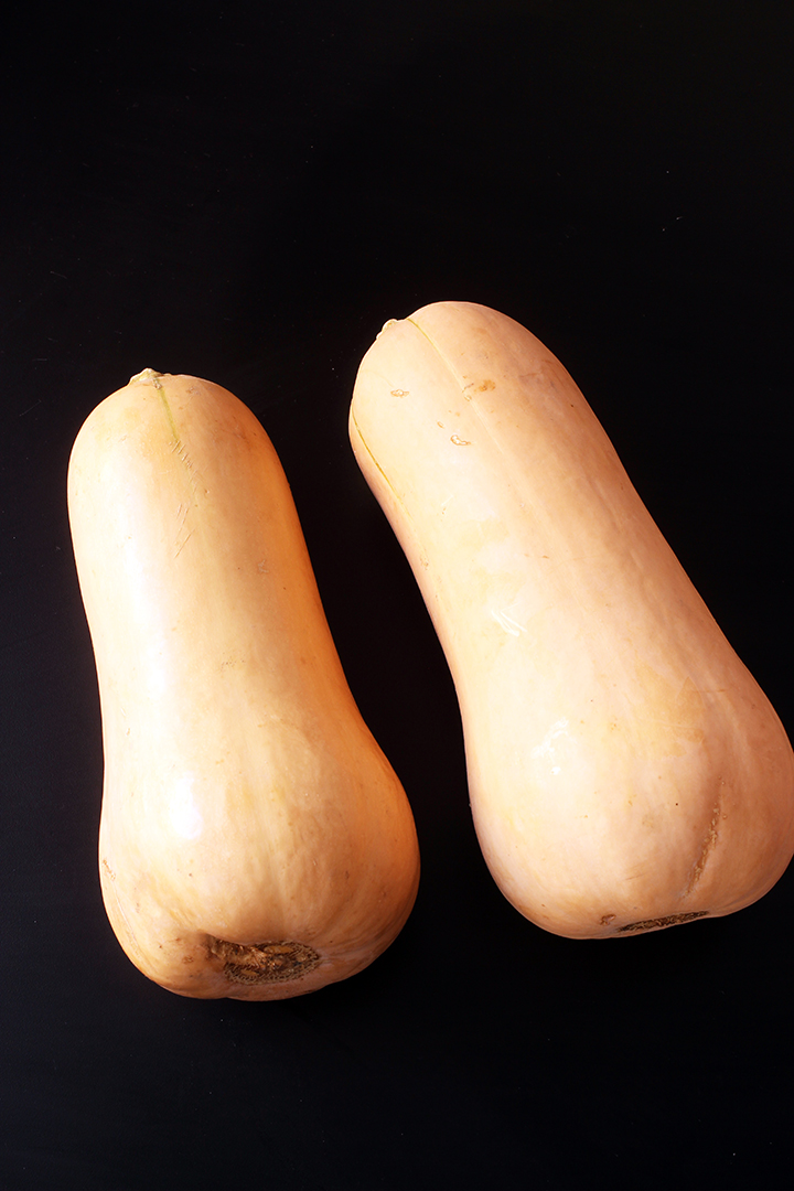 two Butternut Squash on black table