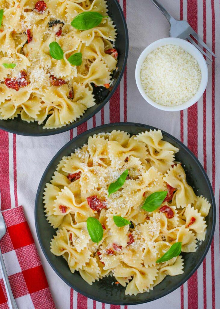 the completed pasta in bowls with basil garnish.