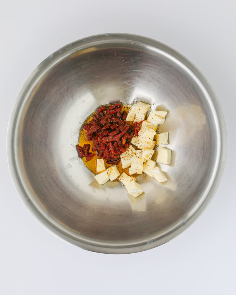 cheese, oil, and tomatoes in the bowl.