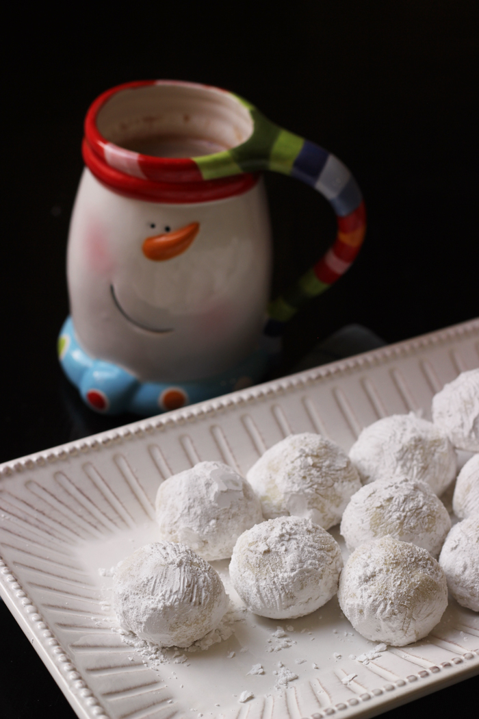 tray of snowball cookies with snowman mug