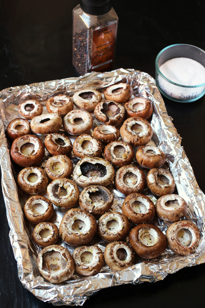 mushroom caps on a foil lined tray