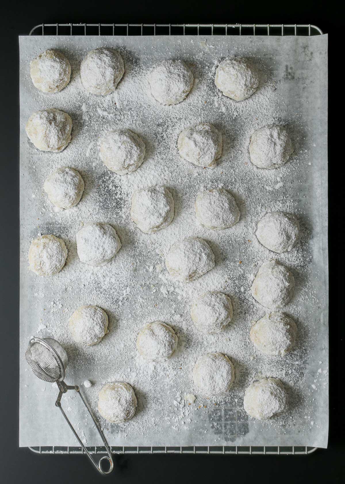 cookie balls coated with powdered sugar.