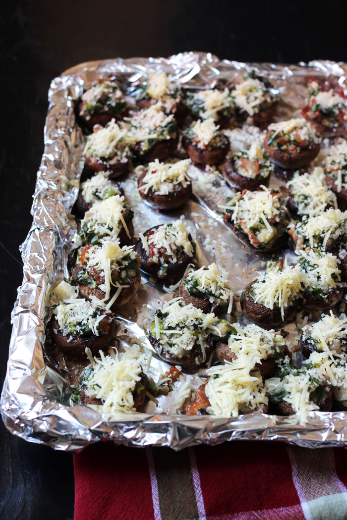 lined tray with stuffed mushrooms ready to broil