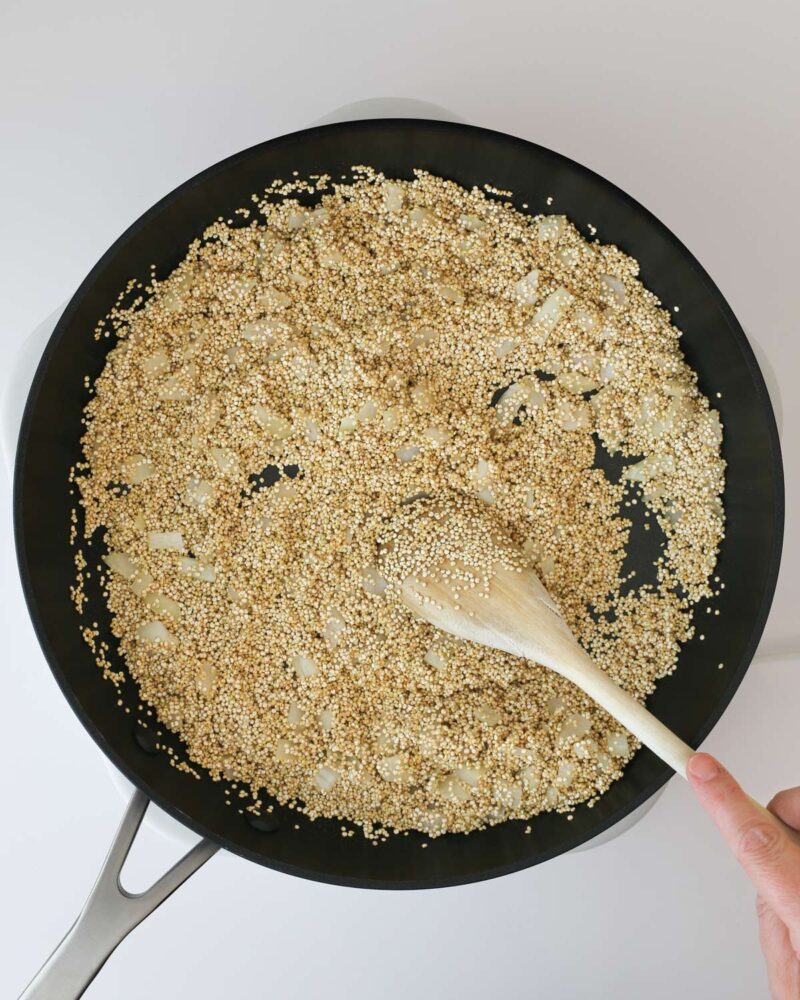 toasting the quinoa and onion in the skillet, stirring with a wooden spoon.