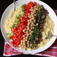 ingredients layered over couscous for salad