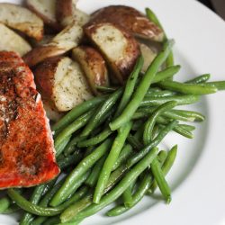 A plate of green beans, potatoes, and salmon