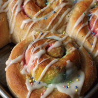 rainbow breakfast rolls with sugar glaze and sprinkles