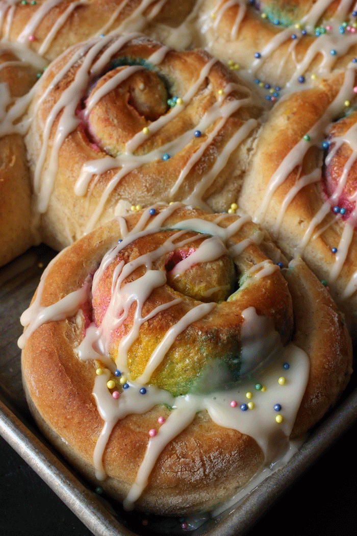 rainbow breakfast rolls with sugar glaze and sprinkles
