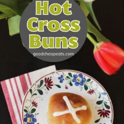 hot cross bun on flowered plate with bouquet of tulips, with text overlay.