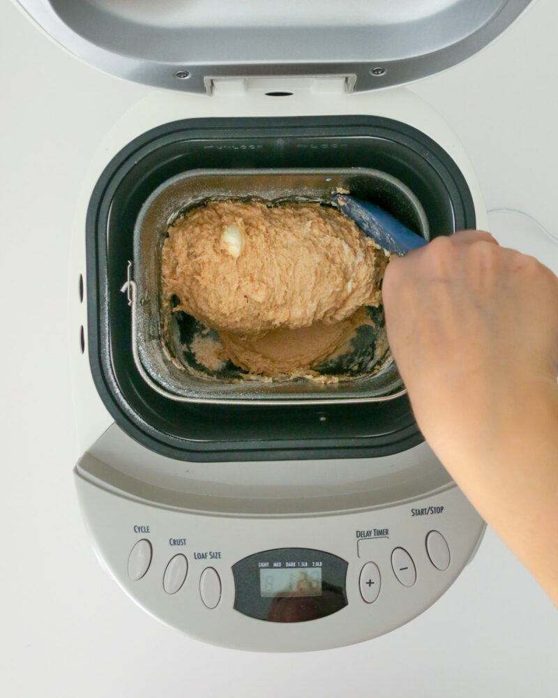 scraping the sides of the pan with spatula.