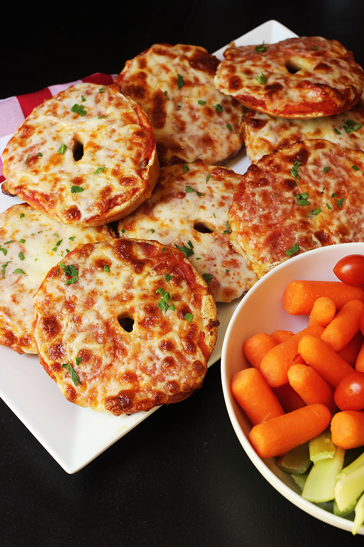 bowl of veggies and platter of pizza bagels