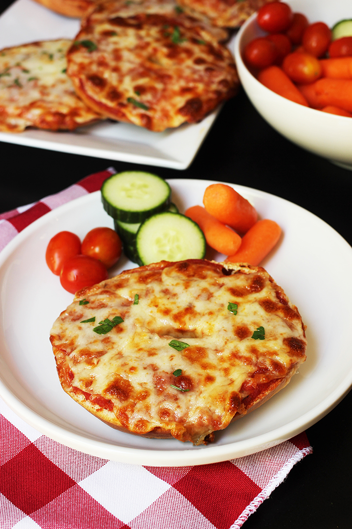 pizza bagel on plate with veggie dippers