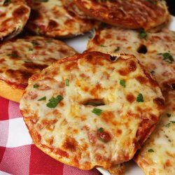 pizza bagels on tray with red checked cloth