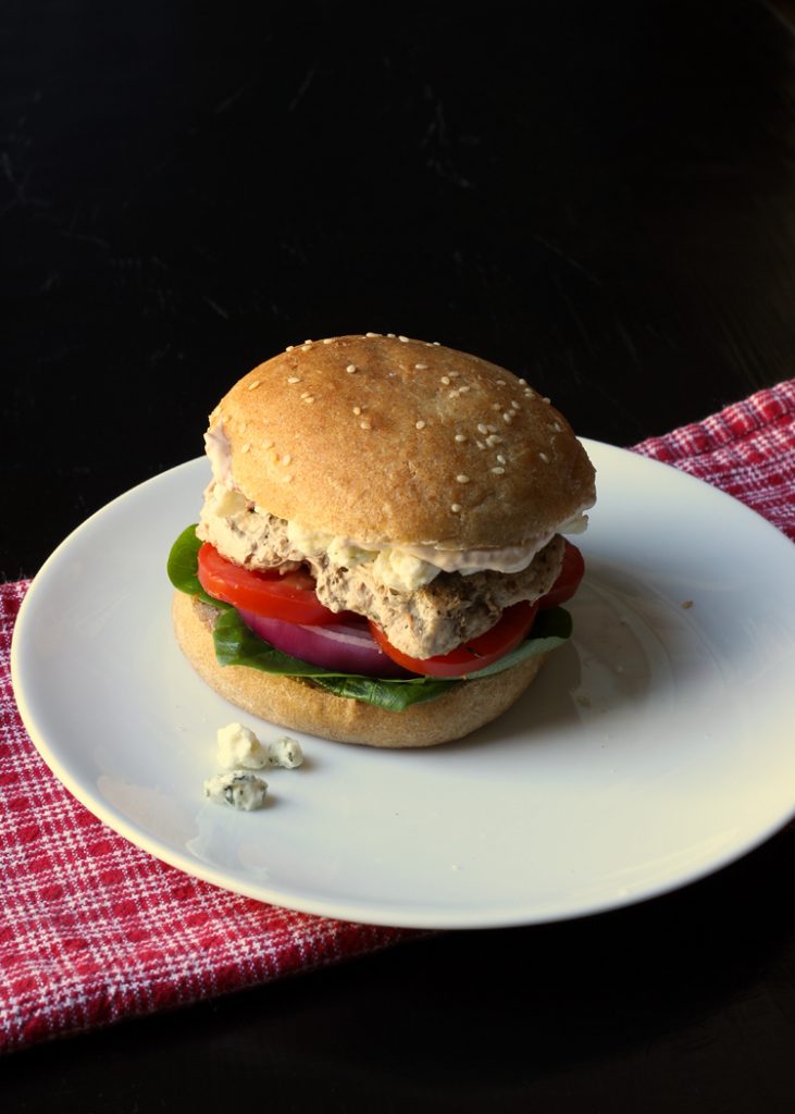 turkey burger on plate with blue cheese crumbles