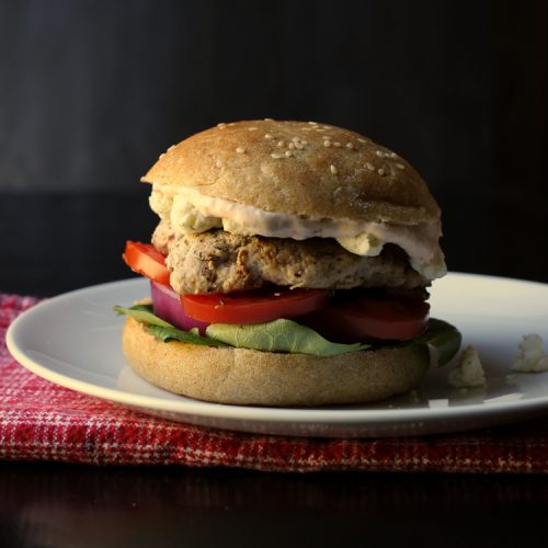 A close up of a burger on a plate