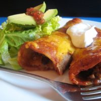 enchiladas on a plate with fork