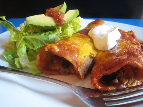 enchiladas on a plate with fork