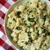 big white bowl of potato salad on red checked cloth