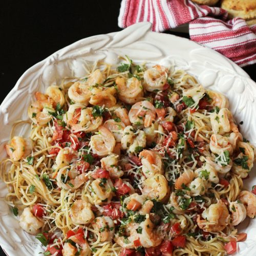 A dish is filled with pasta and shrimp