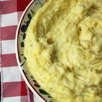 bowl of alfredo mashed potatoes on red checked cloth