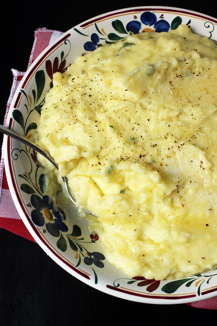 bowl of mashed potatoes with melted butter and fresh pepper