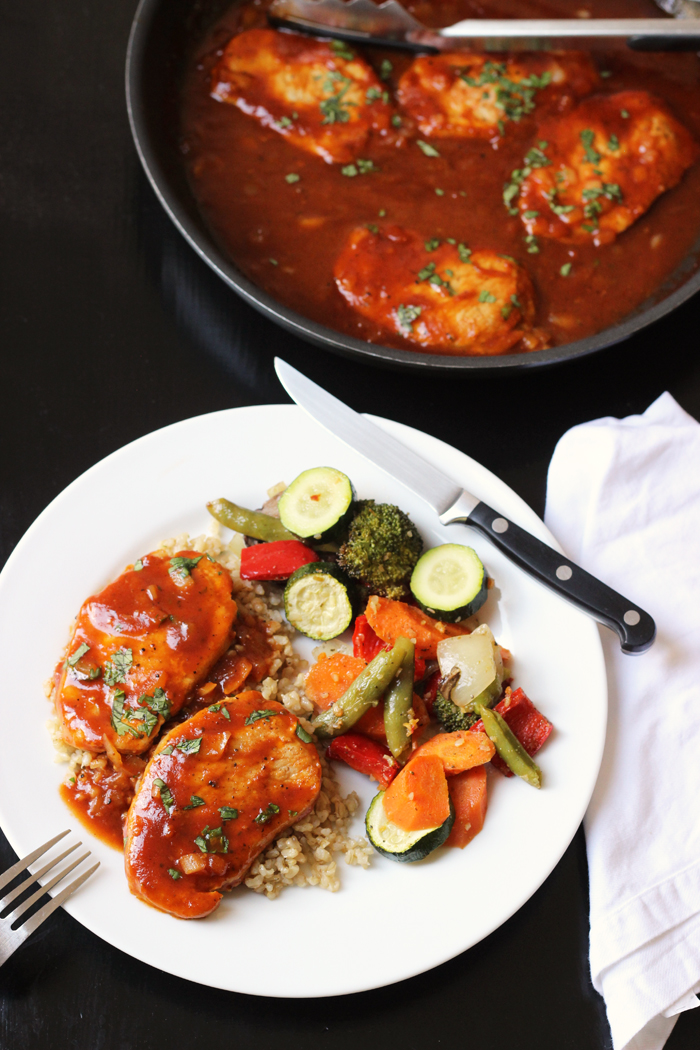 A plate of BBQ pork chops on plate with vegetables