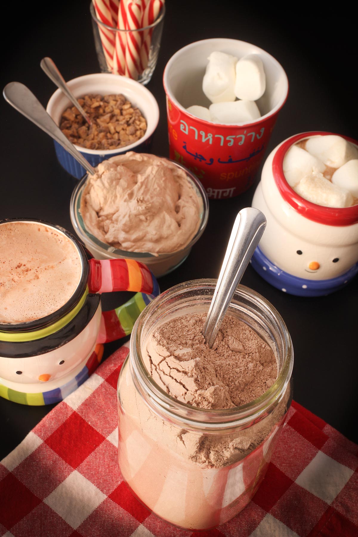 hot cocoa bar with mix, snowman mugs and cocoa toppings