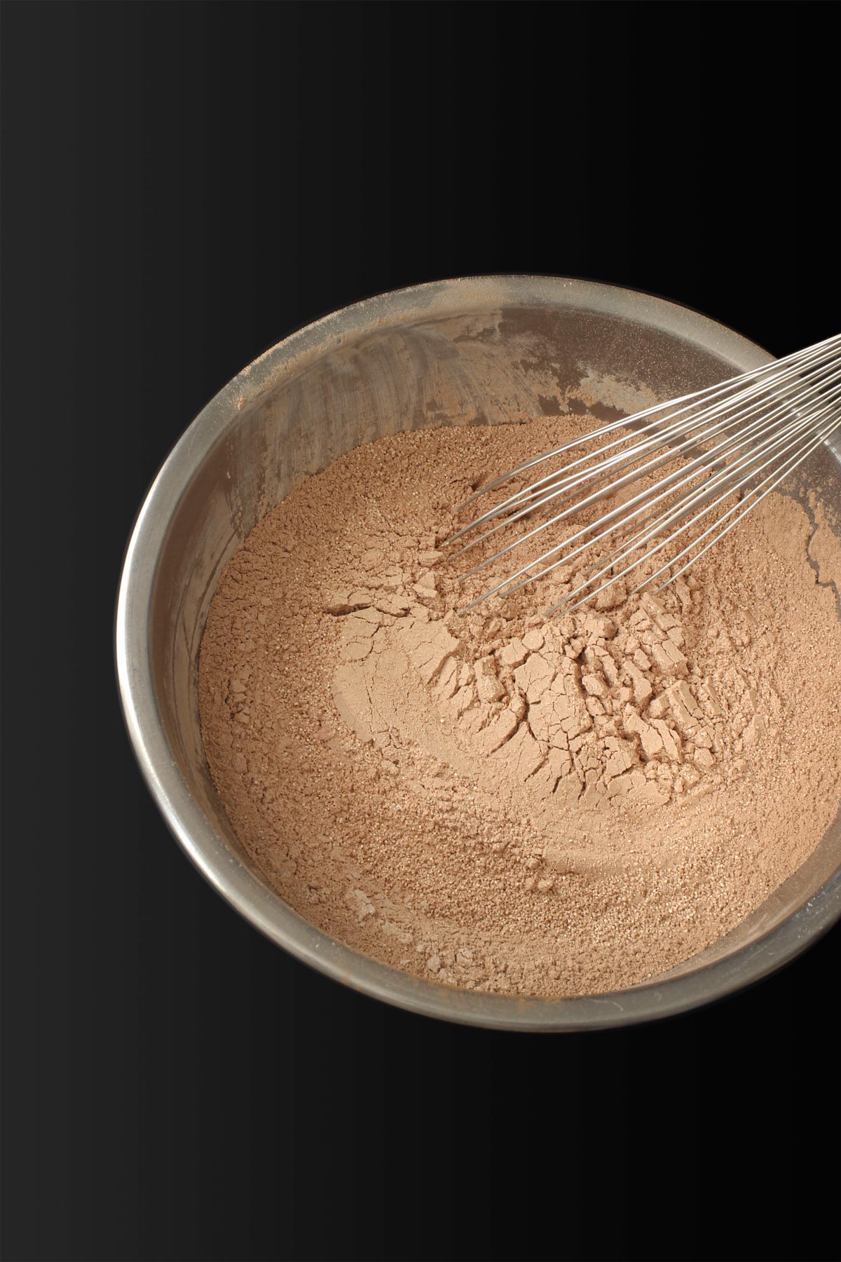 whisked hot chocolate ingredients in metal mixing bowl.