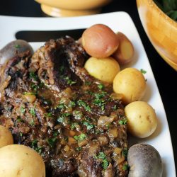 pot roast on platter with tri-color potatoes