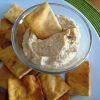 A plate of pita chips and hummus