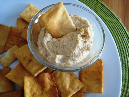 A plate of pita chips and hummus