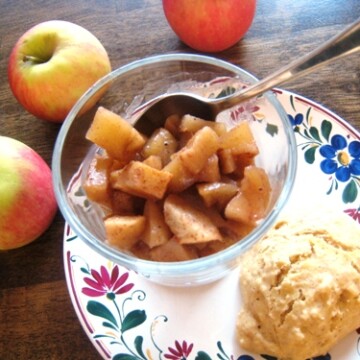 A bowl of compote and apples on table