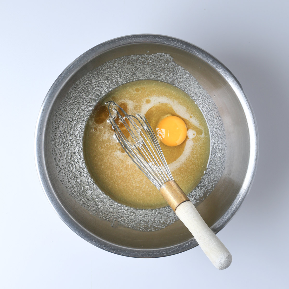 sugar, oil, egg, and vanilla in bowl.