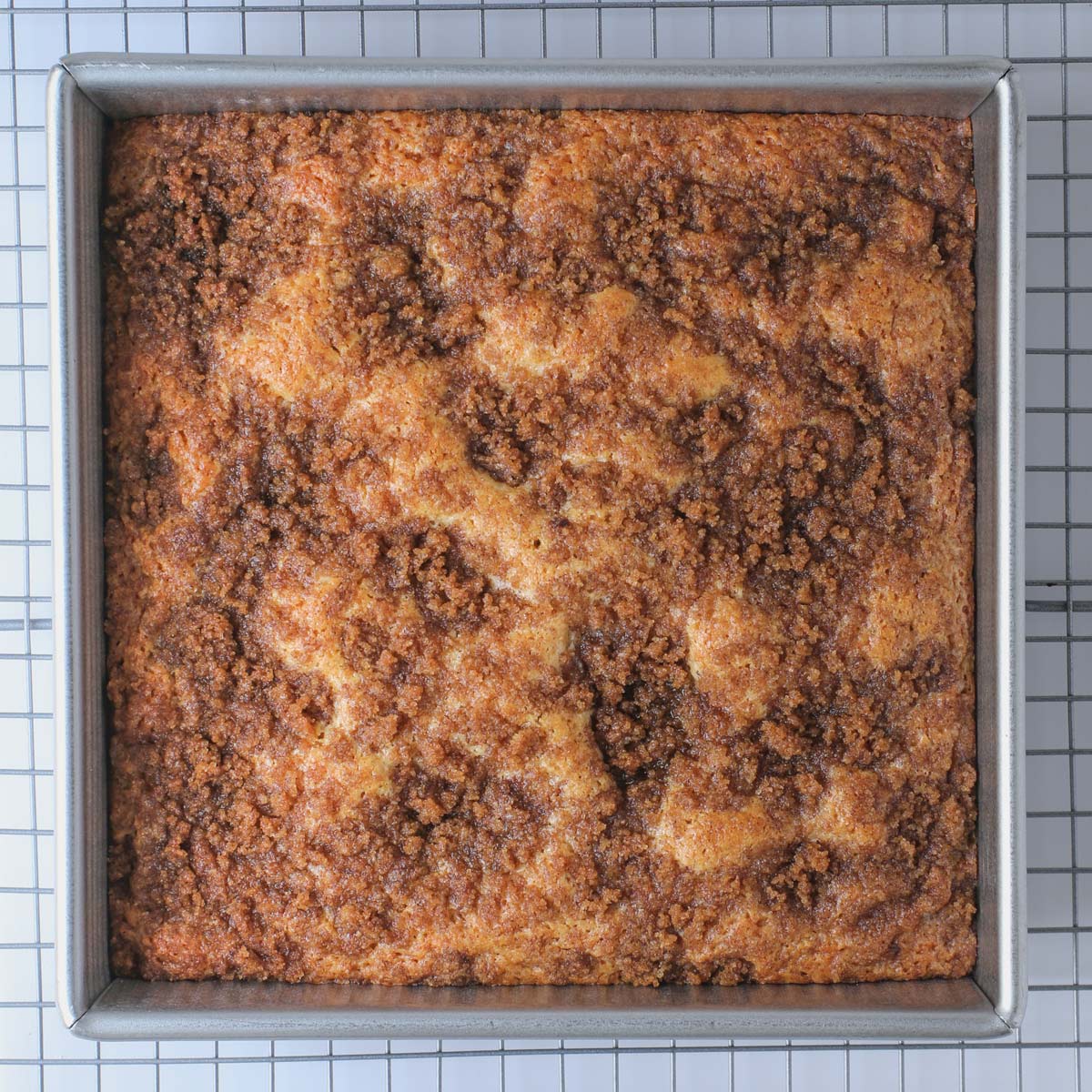 baked cinnamon coffee cake cooling on a wire rack.