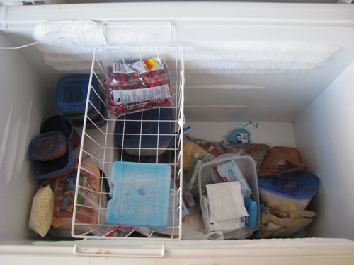 messy deep freezer before tidying