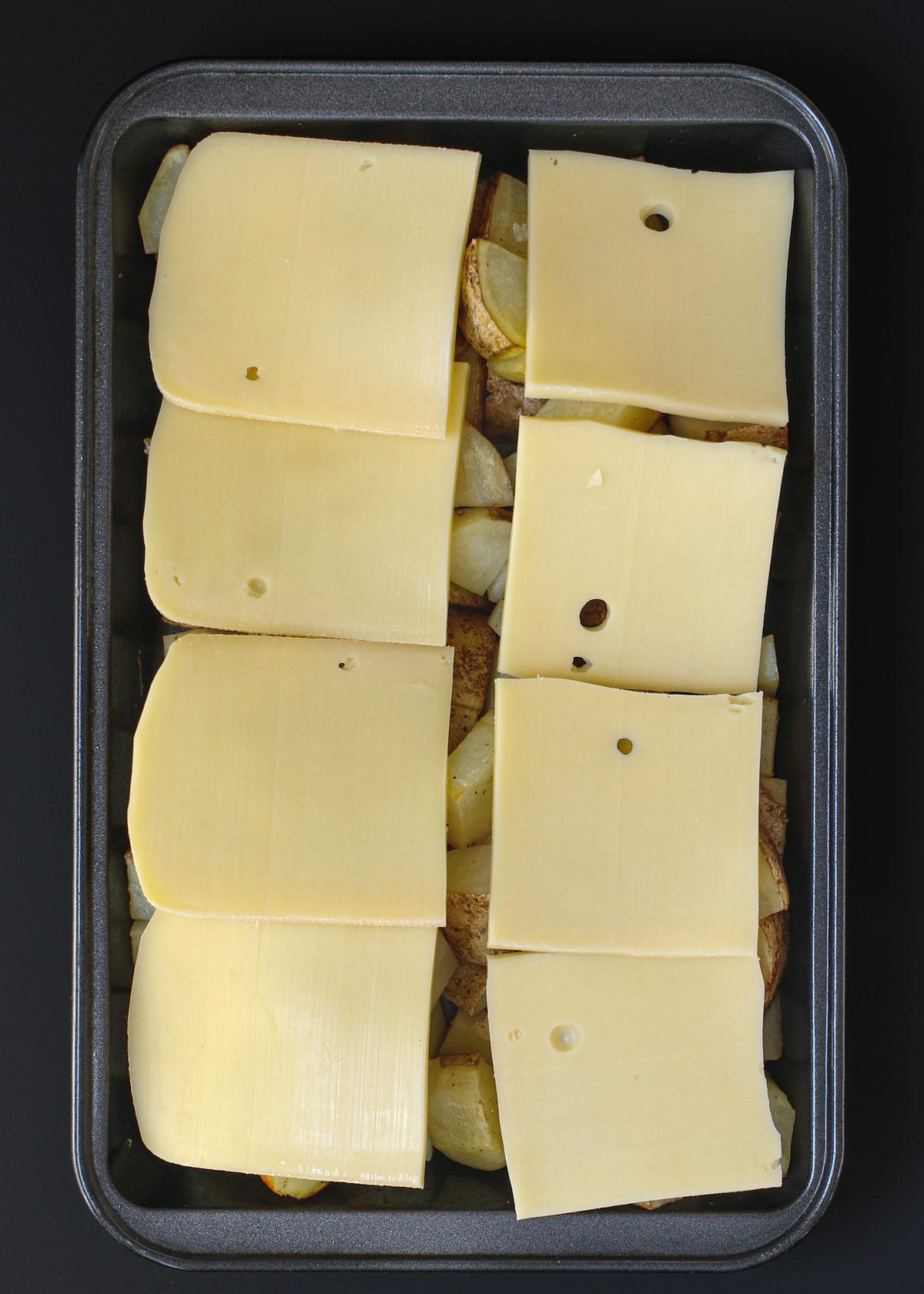 raclette slices layered over the cooked potatoes.