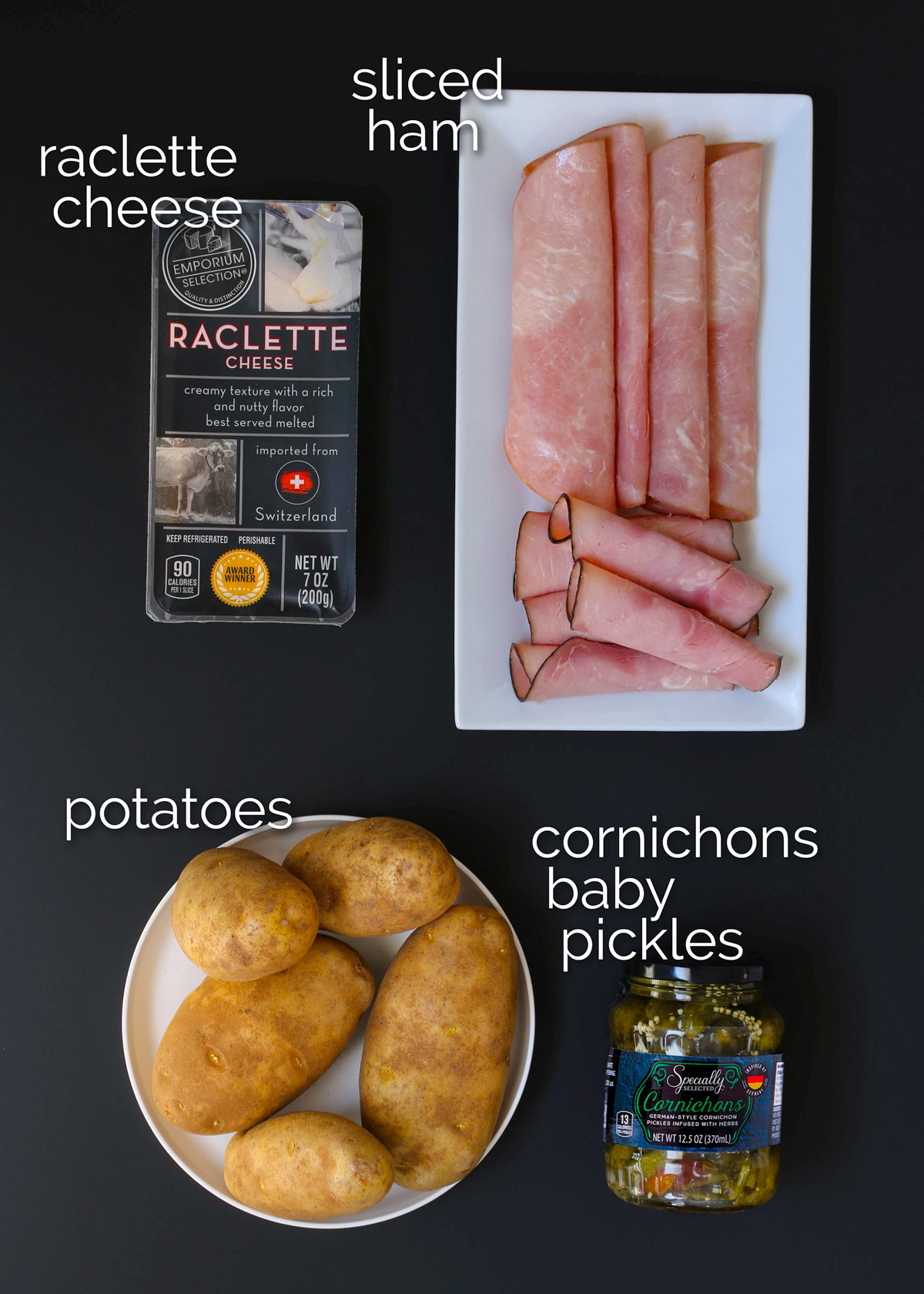 ingredients for raclette recipe laid out on black table top.