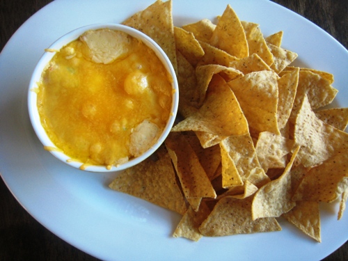 bowl of Jalapeño Cheese Dip on plate of chips