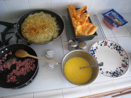 components of big breakfast on stove and counter