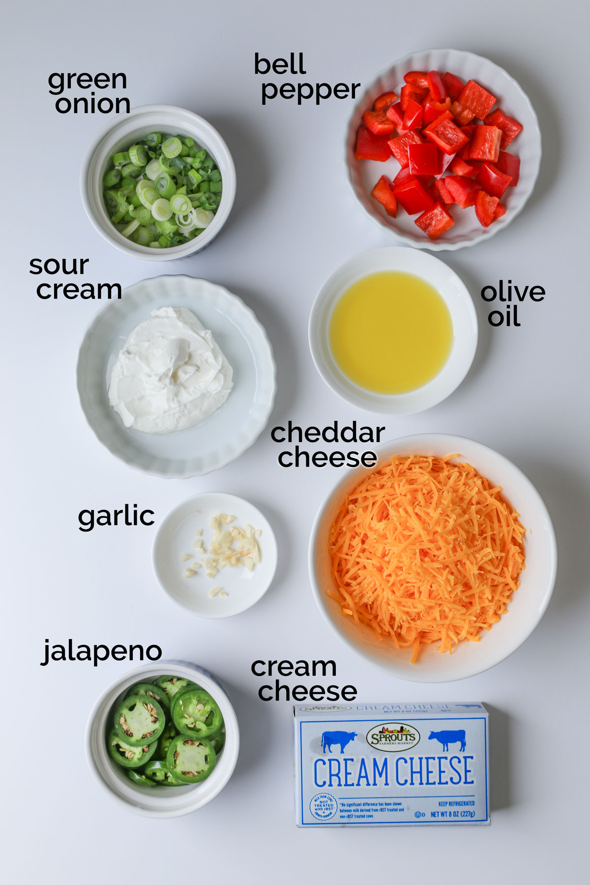 ingredients for jalapeno cream cheese dip laid out on a white counter.