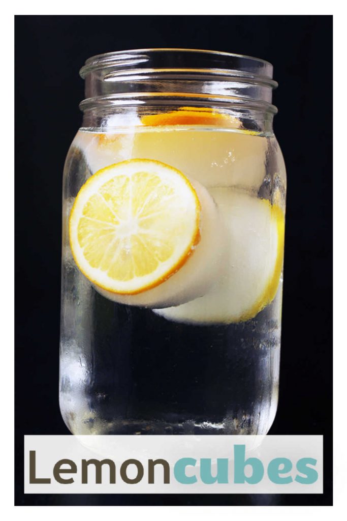 A glass of water with lemon cubes