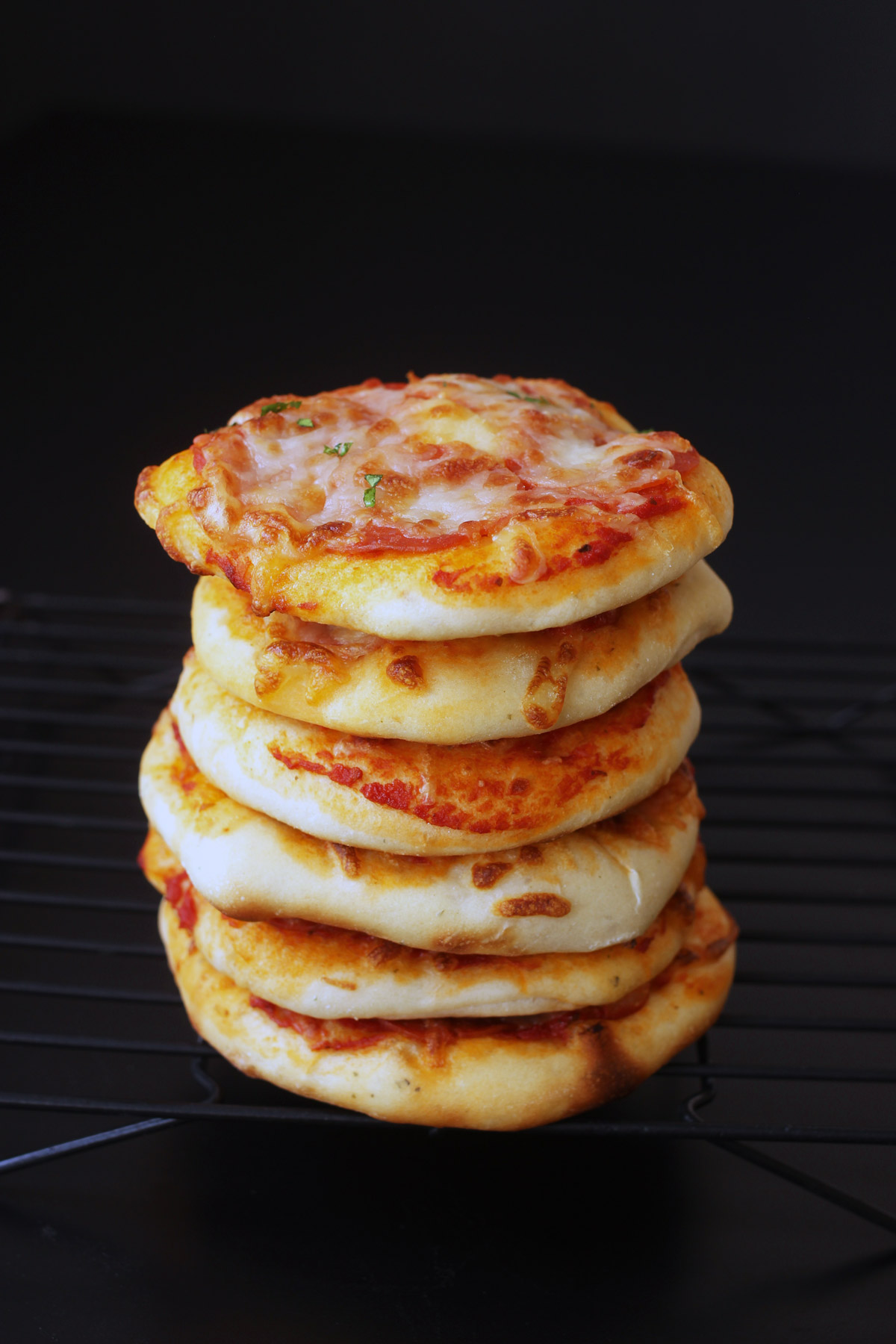 baked and cooled mini pizzas in stack