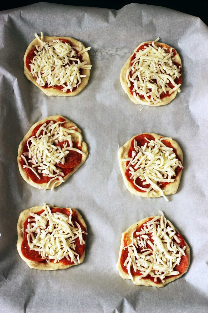 assembled pizzas on pan