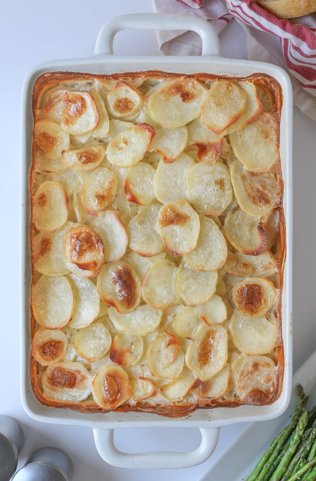 the finished scalloped potatoes in the baking dish.