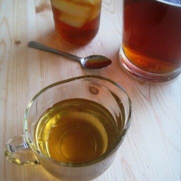 A pitcher of simple syrup next to tea