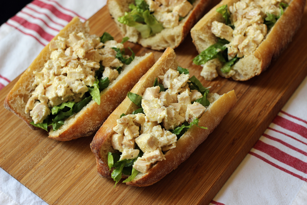 Chicken Caesar Baguette Sandwiches on a cutting board