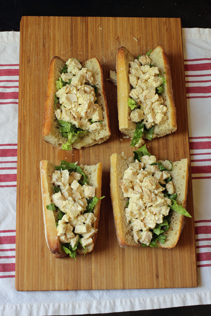 Four Chicken Caesar Baguette Sandwiches on A cutting board